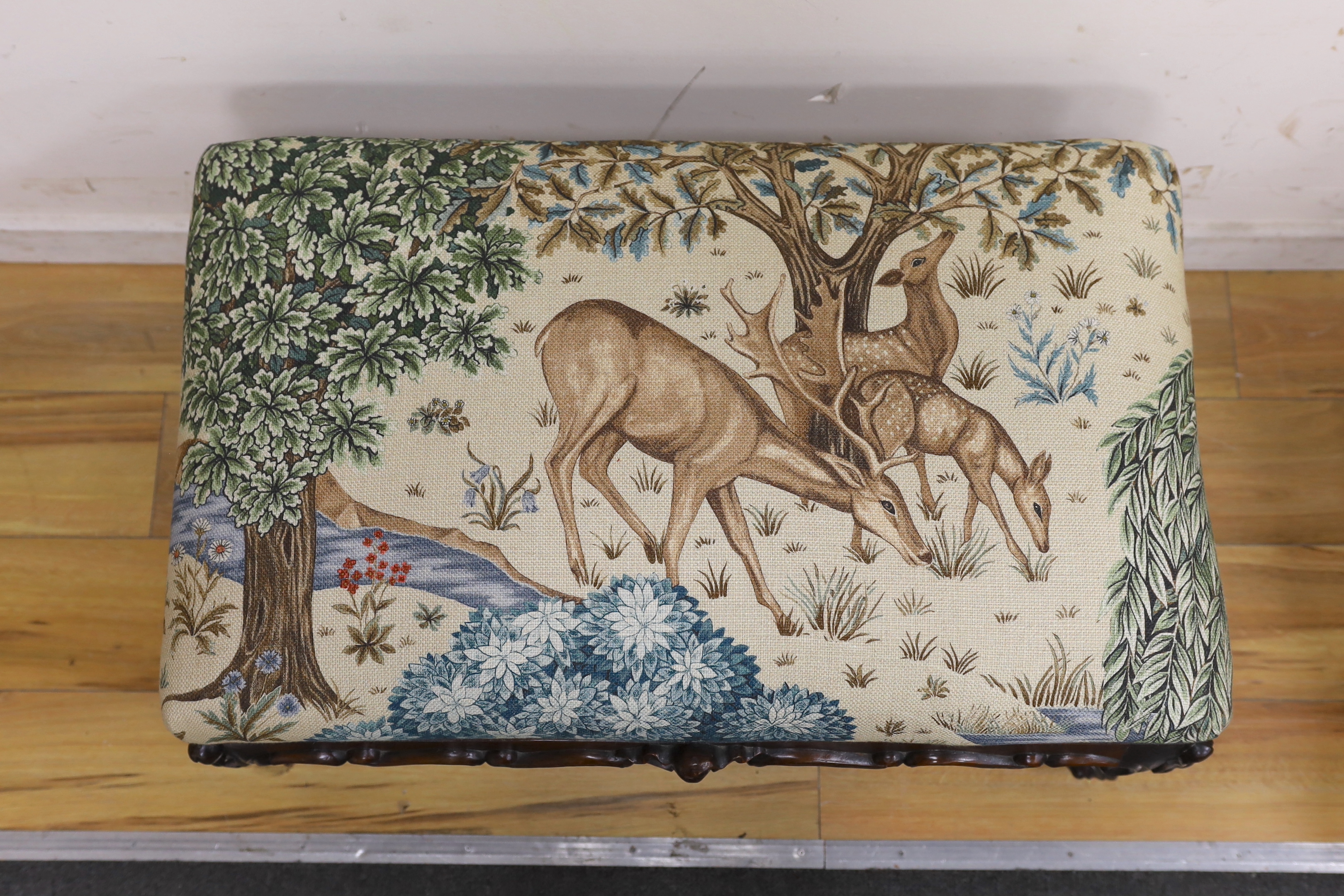 A Victorian carved mahogany dressing stool, re-upholstered in a William Morris-designed fabric, The Brook Tapestry, width 80cm, depth 50cm, height 44cm